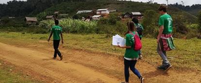 A group of Projects Abroad internship students distributing awareness posters in rural areas during their public health work experience in Madagascar. A photo of internship students from Projects Abroad handing out posters to raise awareness during their public health work experience in Madagascar.